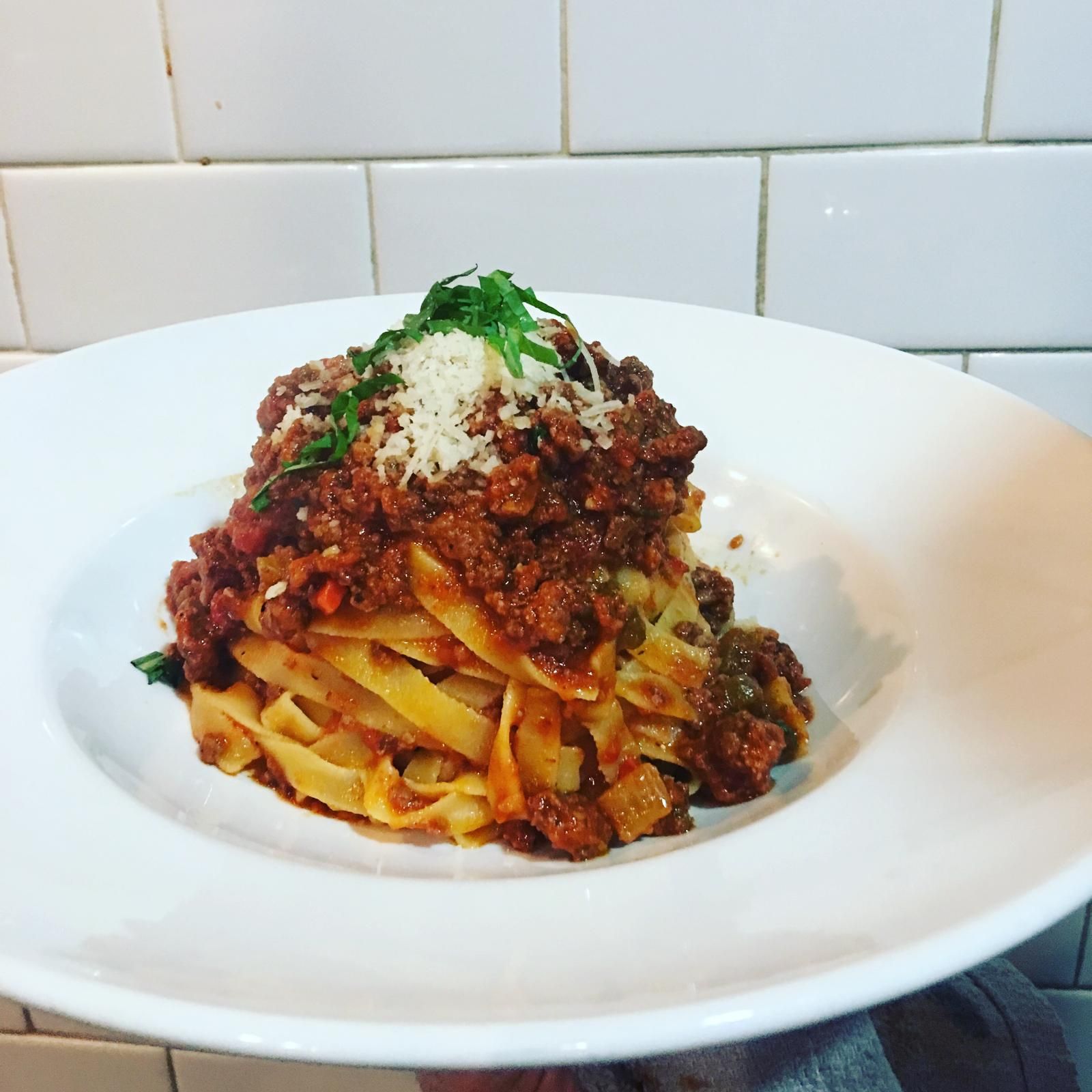 Homemade tagliatelle with a slow-cooked meat ragù and Parmigiano